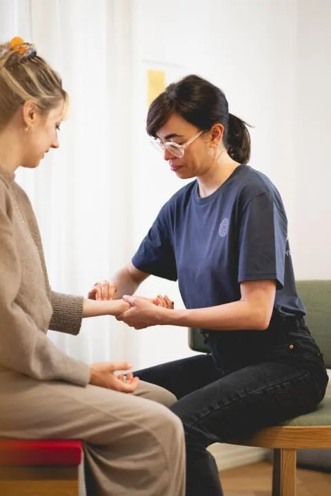 Practitioner checking client's pulse