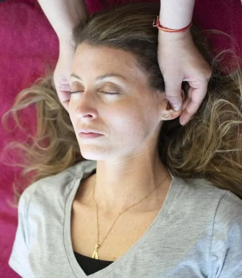 Practitioner performing craniosacral head therapy