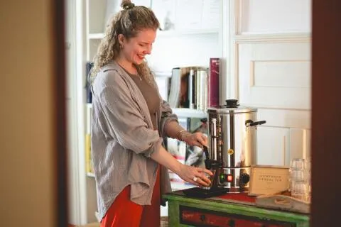 Woman pouring homemade herbal tea